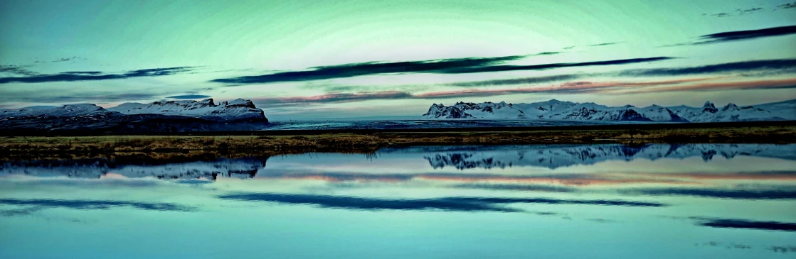 a body of water with mountains in the background, a matte painting, by Þórarinn B. Þorláksson, pexels contest winner, land art, marvellous reflection of the sky, colored analog photography, edited, reykjavik