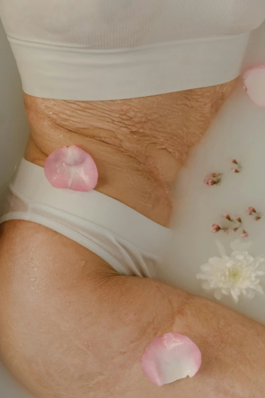 a close up of a person in a bath tub, soft flowers, belly button showing, age lines, made of silk paper