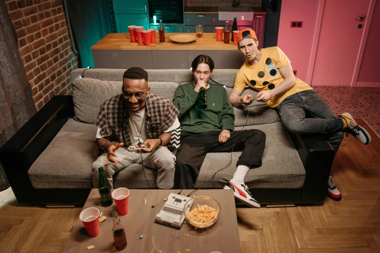 a group of people sitting on top of a couch, an album cover, pexels, gamer themed, baggy jeans, eating pizza, cinematic outfit photo