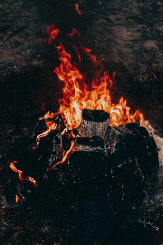 a fire burning in the middle of a field, pexels contest winner, traditional fireplace, floating embers, charred, avatar image