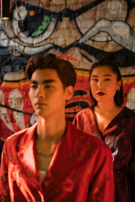 a group of people standing next to each other, an album cover, trending on pexels, visual art, wearing a red cheongsam, couple portrait, looking threatening, alessio albi and shin jeongho