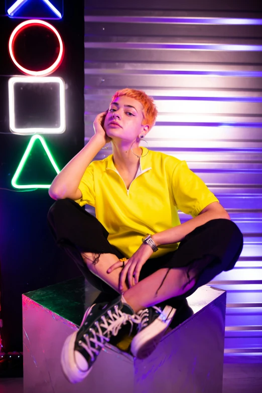 a woman sitting on top of a box next to a neon sign, trending on pexels, aestheticism, shaved sides short top, colors: yellow, casual streetwear, collared shirt