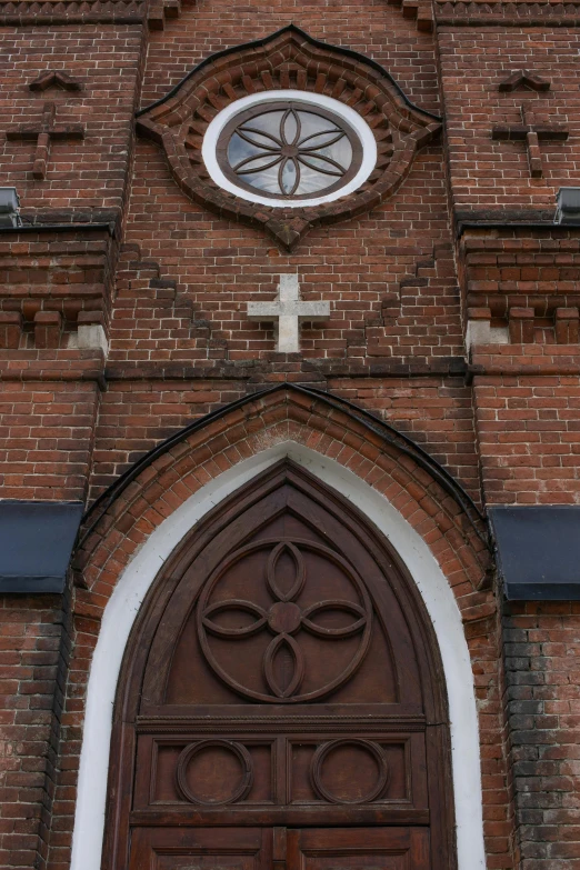 a church with a cross on the front of it, fan favorite, pareidolia, brick building, symbols