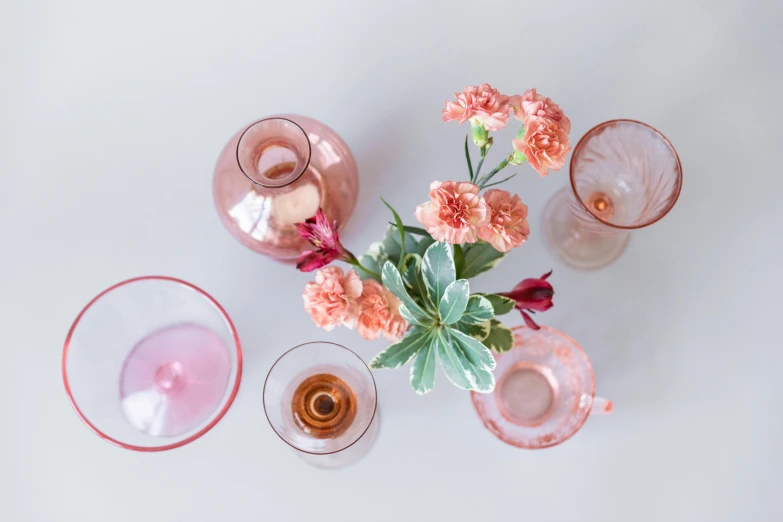 a vase filled with pink flowers sitting on top of a table, by Carey Morris, trending on unsplash, glassware, set against a white background, various posed, cheers