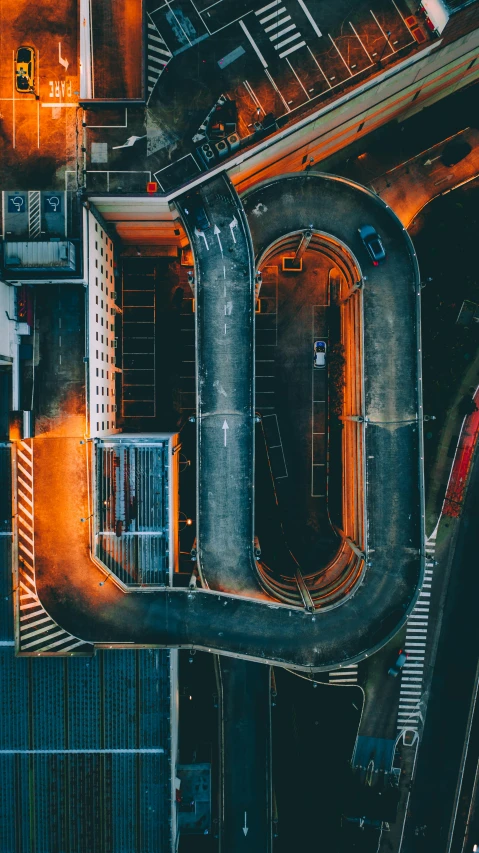 an aerial view of a city street at night, unsplash contest winner, hypermodernism, conveyor belts, black and orange, on a racetrack, portrait photo