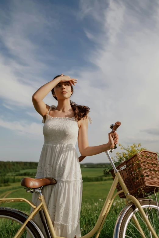 a woman standing next to a bicycle in a field, pexels contest winner, renaissance, white sundress, looking at the sky, holding a baguette, expressive pose