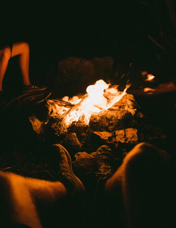 a group of people sitting around a campfire, by Gwen Barnard, pexels contest winner, instagram story, flames around body, profile image, high angle shot