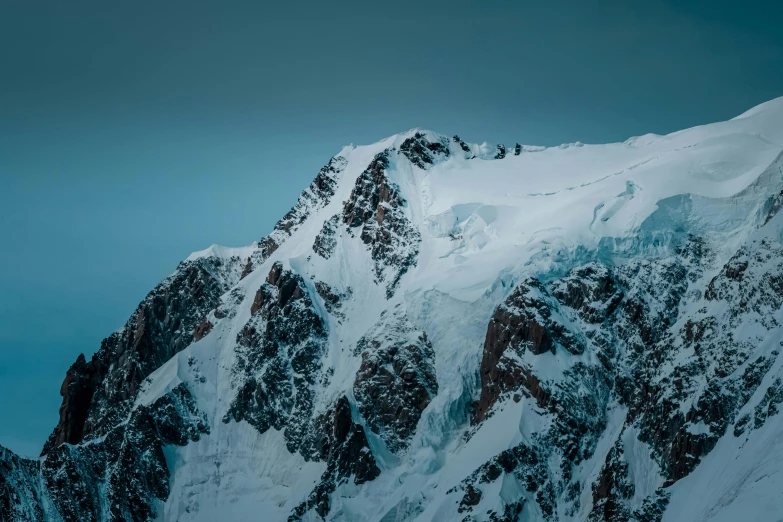 a group of people standing on top of a snow covered mountain, an album cover, pexels contest winner, telephoto photography, “ aerial view of a mountain, cold blue colors, computer wallpaper