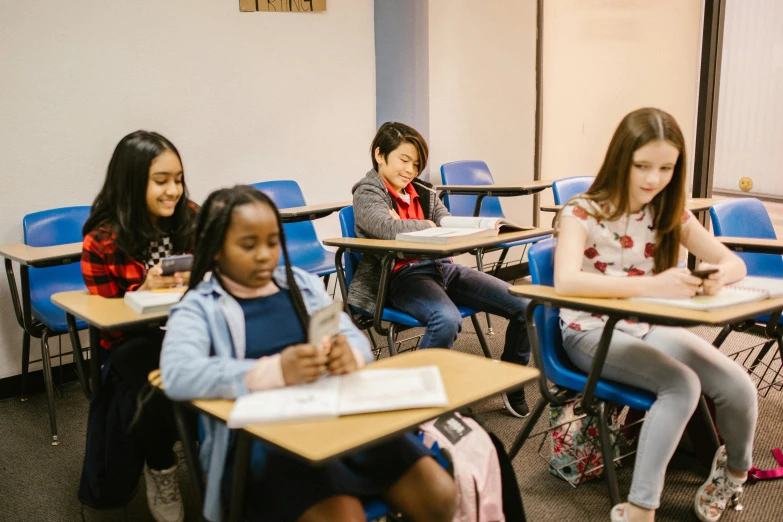 a group of children sitting at desks in a classroom, by Meredith Dillman, pexels contest winner, fan favorite, pokimane, brittney lee, casually dressed