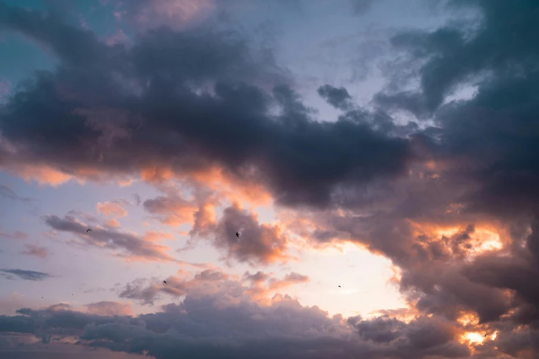 a group of people standing on top of a beach under a cloudy sky, by Carey Morris, pexels contest winner, minimalism, flying through sunset, 3 layers of sky above each other, spaceships in the cloudy sky, ravens stormy sky of foreboding