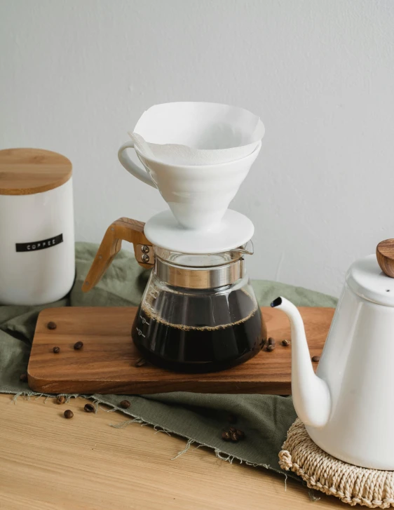 a white coffee pot sitting on top of a wooden table, product image, various items, jakarta, thumbnail