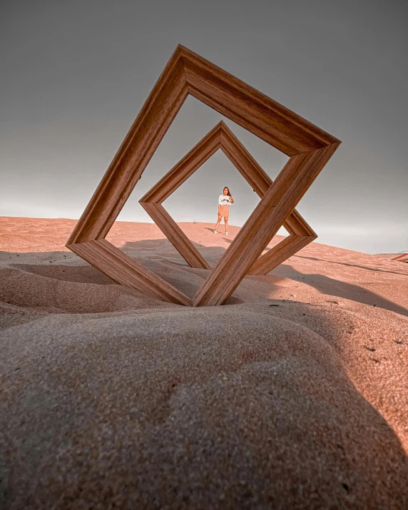 a picture frame sitting on top of a sandy beach, a surrealist sculpture, unsplash contest winner, land art, doors that are cosmic portals, selfie shot straight on angle, behance lemanoosh, square shapes