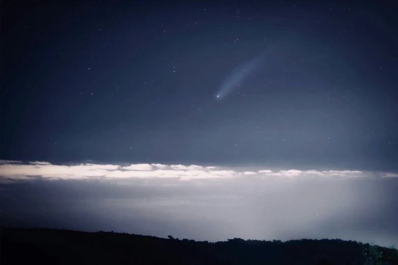 a bright comet shines in the sky above the clouds, happening, still from a nature documentary, promo image, streak lights, icbm