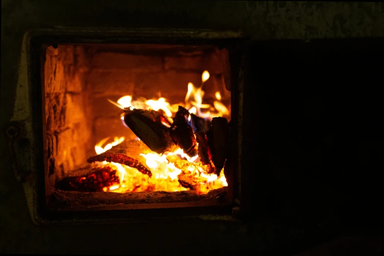 a close up of a fire in a brick oven, pexels, realism, fan favorite, background image, cold freezing nights, a wooden