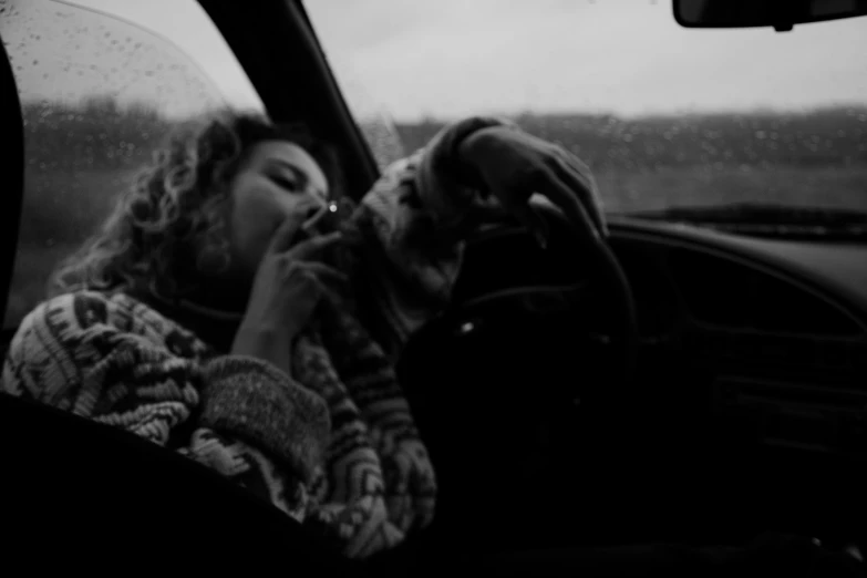 a woman sitting in a car with a dog, a black and white photo, inspired by Louis Faurer, unsplash, realism, smoking weed, he holds her while she sleeps, low quality footage, doja cat