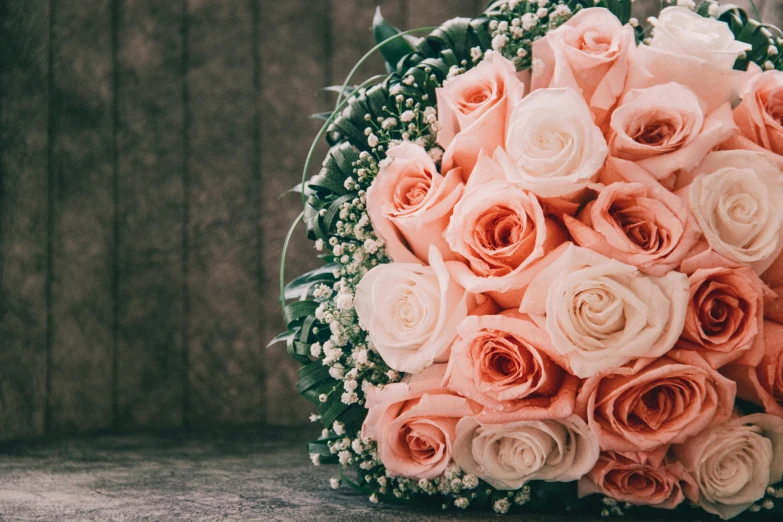 a bouquet of pink and white roses on a table, subtle detailing, highly polished, grainy, toned orange and pastel pink