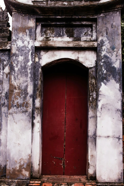 a very old building with a red door, dark tomb setting, bao pnan, peeling paint, maroon