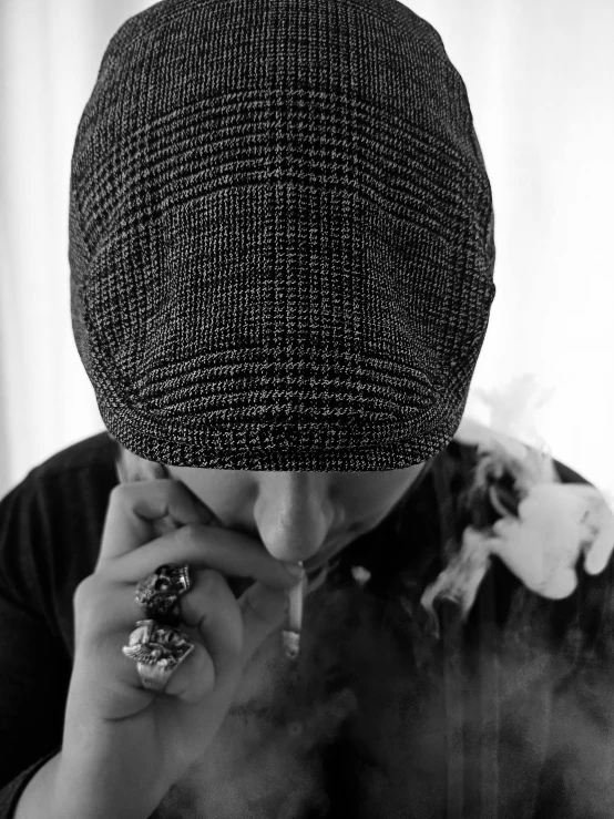 a black and white photo of a man smoking a cigarette, a black and white photo, by Christen Dalsgaard, unsplash, visual art, with rap cap on head, faceless, his head covered in jewels, pete davidson
