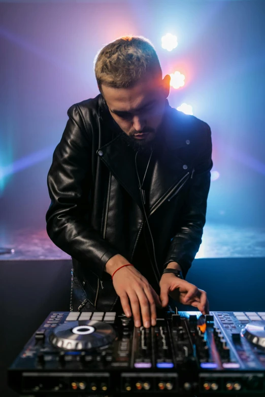 a man that is standing in front of a mixer, inspired by Ottó Baditz, trending on pexels, wearing a black jacket, performing, a blond, leather clothing