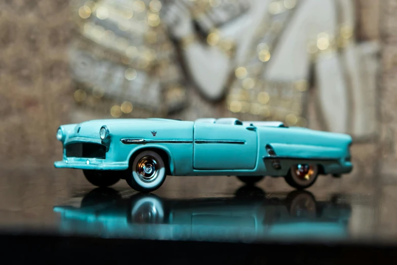 a toy car sitting on top of a table, by Tom Bonson, pexels contest winner, turquoise gold details, 5 0 s style, micro detail, convertable