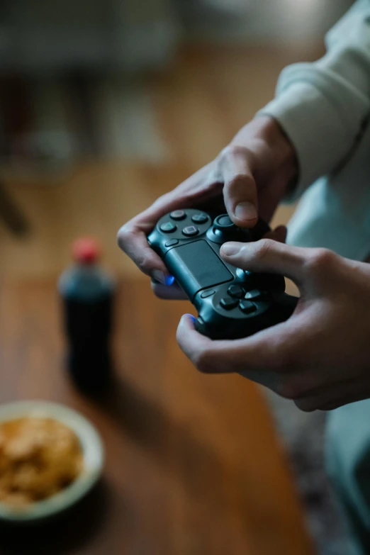 a close up of a person holding a video game controller, video games, food, pray, paul barson