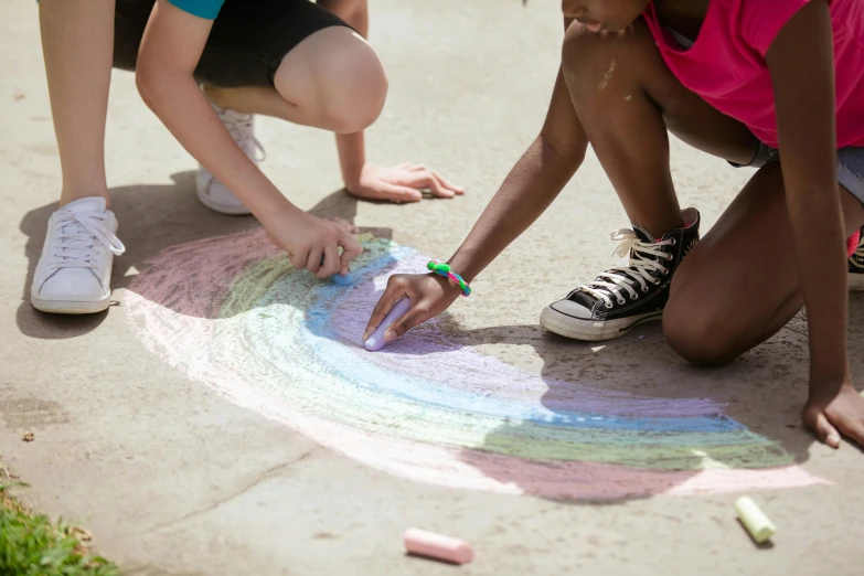 two girls are drawing with chalk on the sidewalk, by Arabella Rankin, pexels contest winner, interactive art, rainbow colored, in a circle, tonal colors outdoor, thumbnail