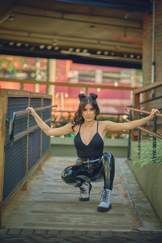 a woman posing for a picture on a bridge, an album cover, by Julia Pishtar, unsplash, kylie jenner as catwoman, squatting pose, :: madison beer, cosplay photo