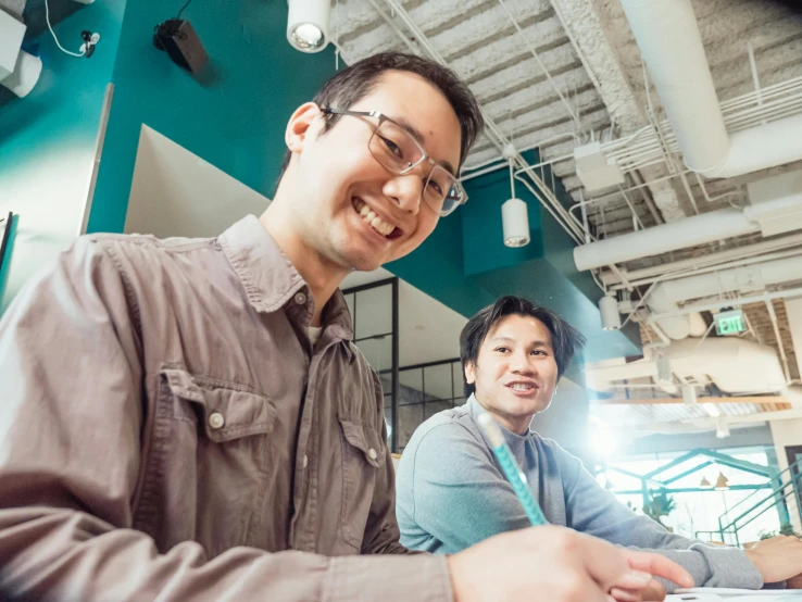 a man and a woman sitting at a table, unsplash, happening, zeen chin and terada katsuya, avatar image, bottom angle, smiling slightly