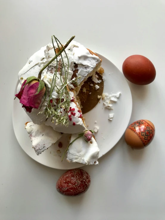 a white plate topped with a cake covered in whipped cream, a still life, by Daniel Lieske, unsplash, easter, 👰 🏇 ❌ 🍃, an egg, decorated with flowers