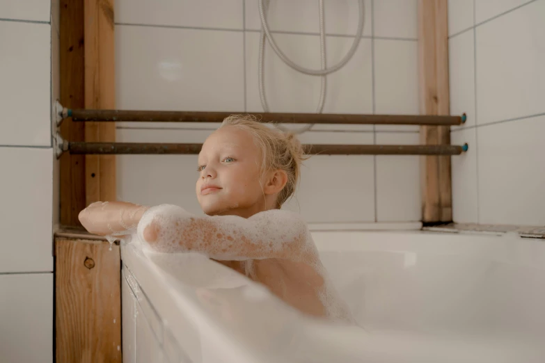 a little girl taking a bath in a bathtub, pexels contest winner, looking her shoulder, a blond, tubes, boys