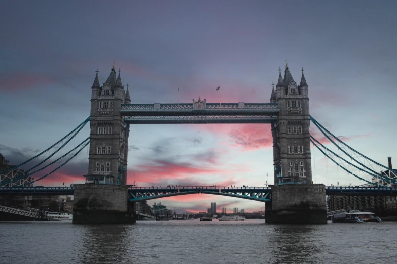 a bridge over a body of water at sunset, pexels contest winner, tower bridge, pink, gray, thumbnail