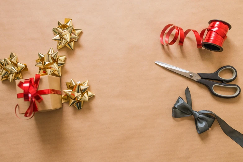 a pair of scissors sitting on top of a table, pexels contest winner, arts and crafts movement, birthday wrapped presents, tiny stars, golden pommel, plastic wrap