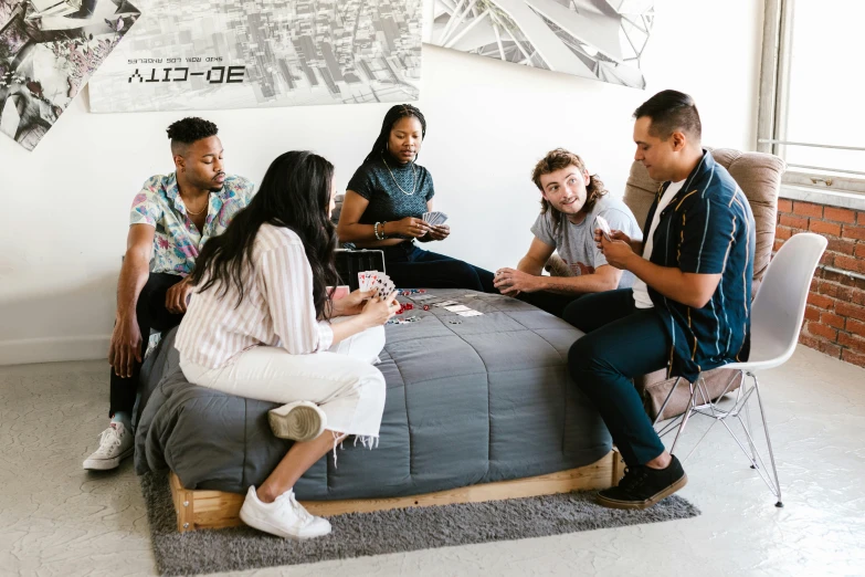 a group of people sitting on top of a bed, pexels contest winner, renaissance, casual game, bay area, furniture around, on a white table