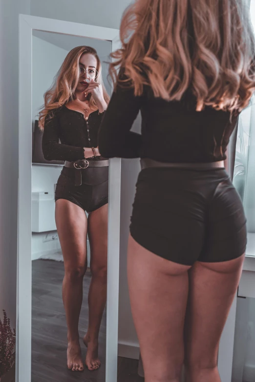 a woman that is standing in front of a mirror, by Adam Marczyński, booty shorts, wearing a black bodysuit, profile image, 🐎🍑