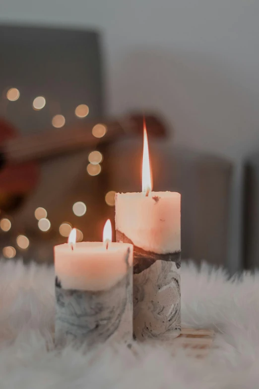 a couple of candles sitting on top of a table, a marble sculpture, trending on pexels, romanticism, christmas lights, profile image, pastel lighting, indoor picture