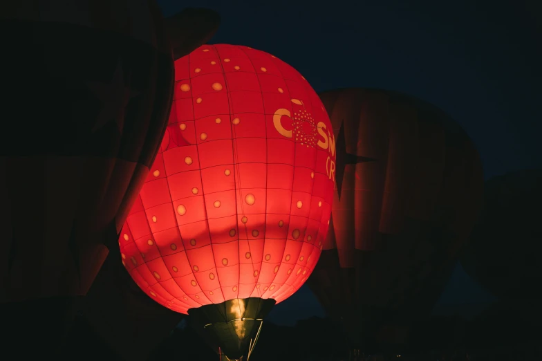 a red hot air balloon lit up at night, by Cosmo Alexander, happening, close-up shot taken from behind, tea drinking and paper lanterns, event photography, pink