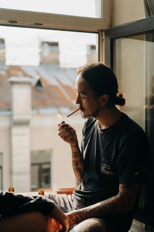 a man sitting on a window sill smoking a cigarette, pexels contest winner, smoking a bowl of hash together, profile image, frank dillane, sitting in a cafe