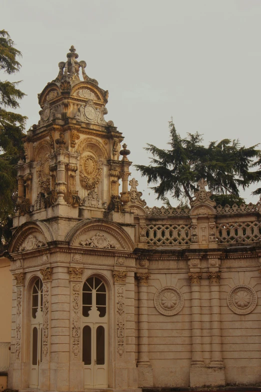 a building with a clock on the top of it, inspired by Emiliano Di Cavalcanti, baroque, torri gate, tlaquepaque, not enough details, the empress’ swirling gardens