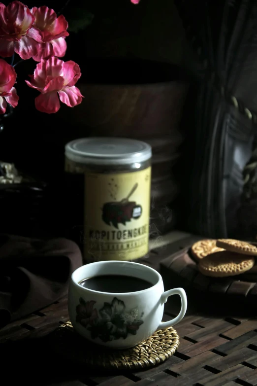 a close up of a cup of coffee on a table, a still life, inspired by Wlodzimierz Tetmajer, sumatraism, jar on a shelf, promo image, bittersweet, snacks