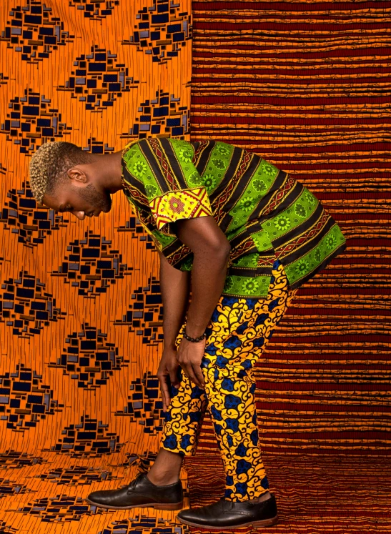 a woman bending down to pick up something, an album cover, by Ingrida Kadaka, patterned clothing, man standing in defensive pose, back view. nuri iyem, brightly coloured
