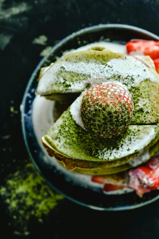 a close up of a plate of food on a table, inspired by Yanagawa Nobusada, trending on unsplash, moss ball, next to sliced strawberries, loputyn and matcha, stacked image