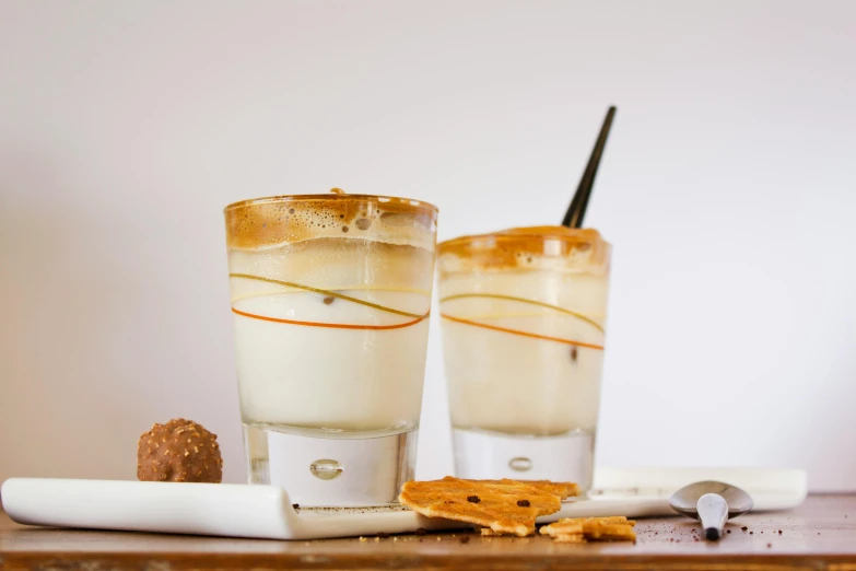 a couple of glasses sitting on top of a table, vanilla smoothie explosion, square, smoked layered, therookies