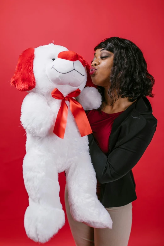 a woman kissing a large white teddy bear, red and white color theme, m & m plush, wig, mkbhd