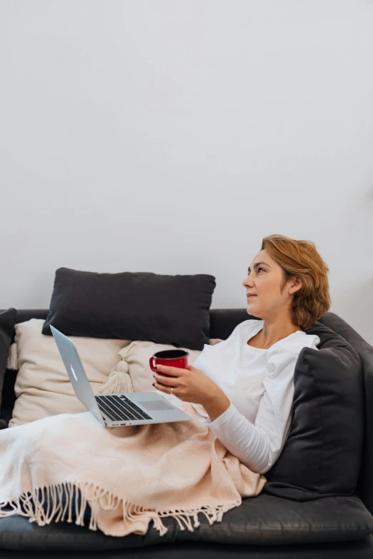 a woman sitting on a couch with a laptop, happening, 6 : 3 0 am, profile image, streaming, super high resolution