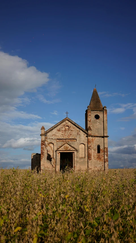 an old church in the middle of a field, an album cover, by Attila Meszlenyi, pexels contest winner, romanesque, (rust), freddy mamani silvestre facade, 15081959 21121991 01012000 4k, kris kuksi