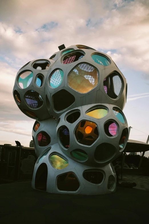 a large white object sitting on top of a parking lot, inspired by Buckminster Fuller, unsplash, interactive art, trypophobia, various colors, reykjavik, pods