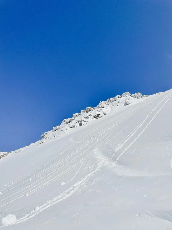 a man riding a snowboard down the side of a snow covered slope, les nabis, clear blue skies, balaskas, profile image, the panorama