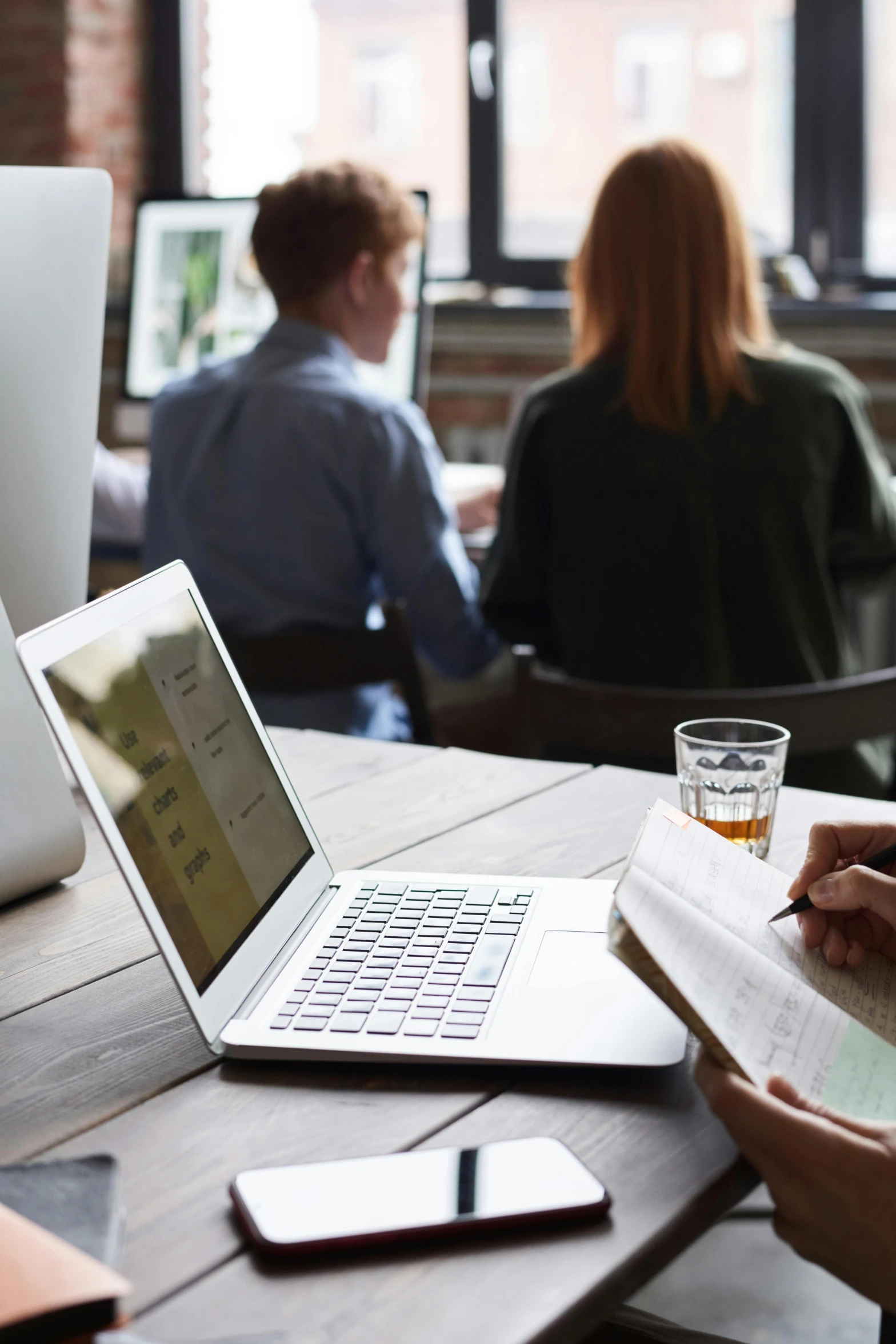 a group of people sitting around a table with laptops, by Carey Morris, trending on unsplash, table in front with a cup, thumbnail, no cropping, profile image