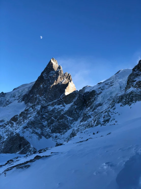 a person standing on top of a snow covered mountain, les nabis, big moon on the right, guillaume tholly, profile image