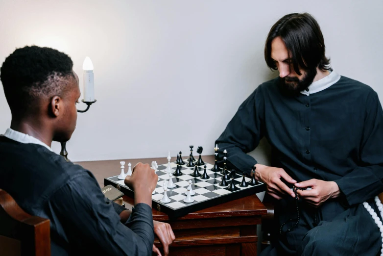 two men sitting at a table playing chess, inspired by Michelangelo Merisi da Caravaggio, pexels contest winner, renaissance, wearing a black noble suit, kara walker james jean, ( ( theatrical ) ), jonny greenwood